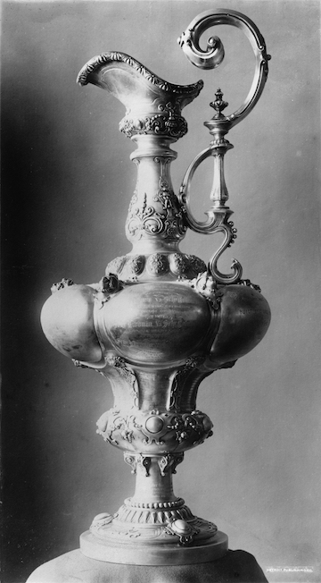 Black and white photograph of the America's Cup. It is a large, quite elaborate jug.